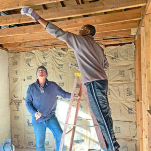 A Zaxby's employee helps renovate a house in Athens, GA