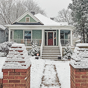 House with a front porch in a light covering of snow