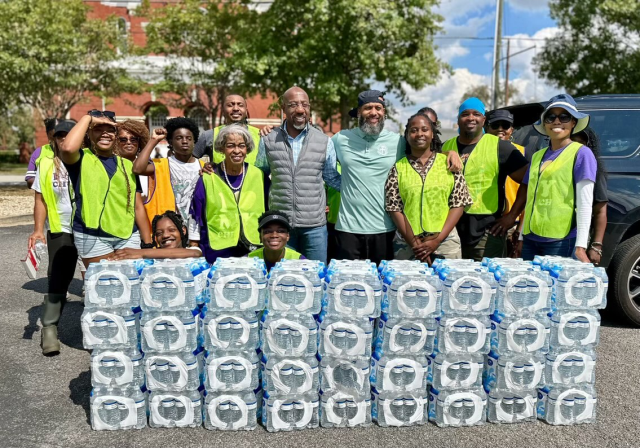 Senator Raphael Warnock and volunteers with water for disaster victims